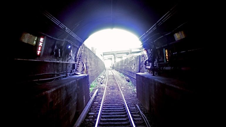 An LIRR train travels east inside an East River Tunnel.