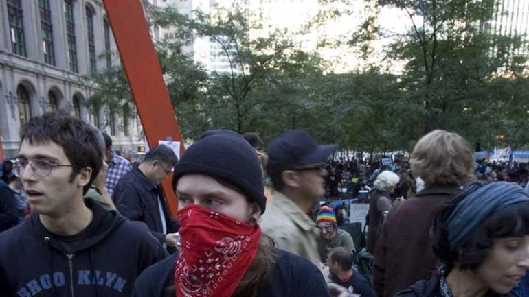 Demonstrators holding signs gather at the Occupy Wall Street rally...