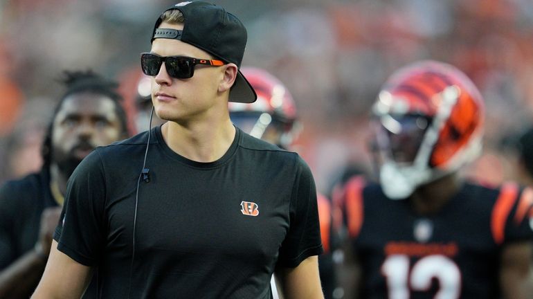 Cincinnati Bengals quarterback Joe Burrow walks on the sideline during...