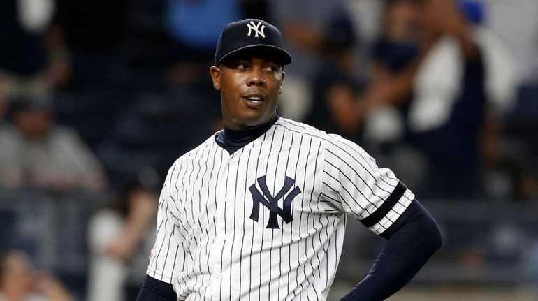 Aroldis Chapman #54 of thek Yankees looks on after surrendering...