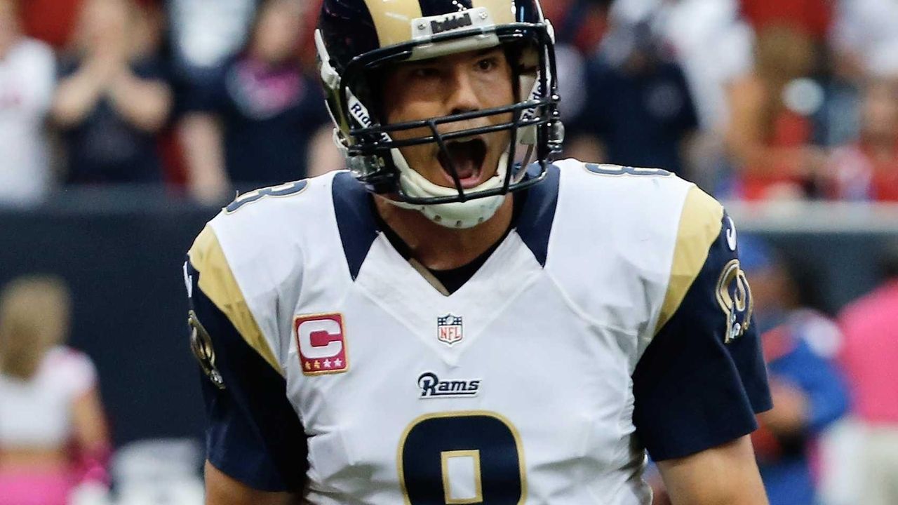 St. Louis Rams starting quarterback Sam Bradford (8) hands the