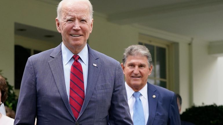 President Joe Biden, with Sen. Joe Manchin, D-W.Va., right, speaks...