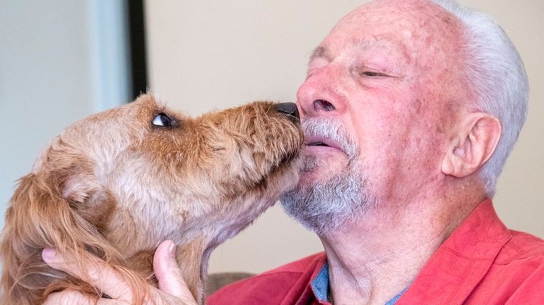 Roy Gross with his goldendoodle, Kaiya.