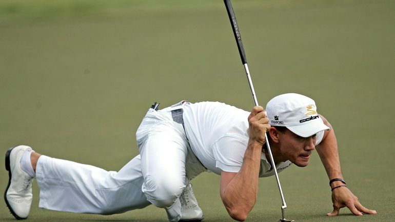 Camilo Villegas lines up a putt on the third green...