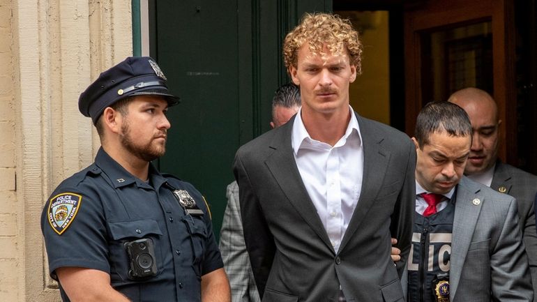 Daniel Penny is led from the Fifth Precinct after surrendering...