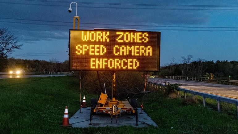 Electronic signs on the Long Island Expressway warn motorists of...