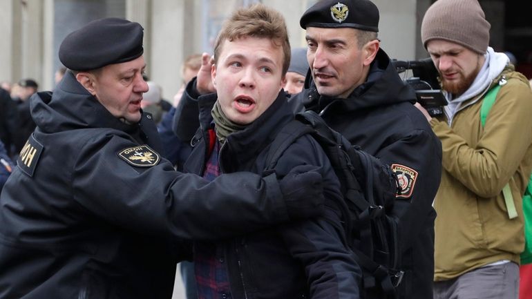 Belarus police arrest journalist Raman Pratasevich, center, in Minsk, Belarus,...