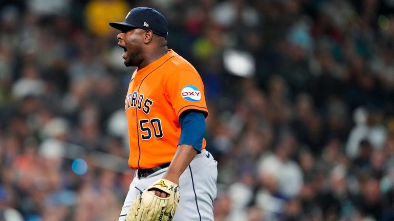 Houston Astros relief pitcher Hector Neris yells after striking out...