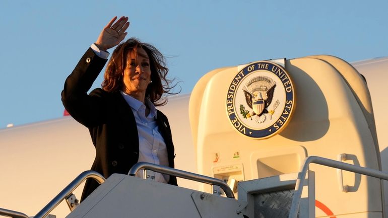 Democratic presidential nominee Vice President Kamala Harris waves as she...