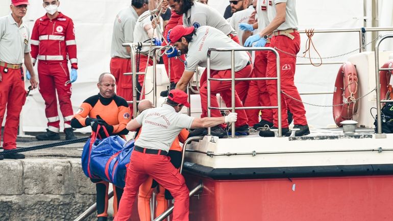 Italian firefighter divers bring ashore in a plastic bag the...