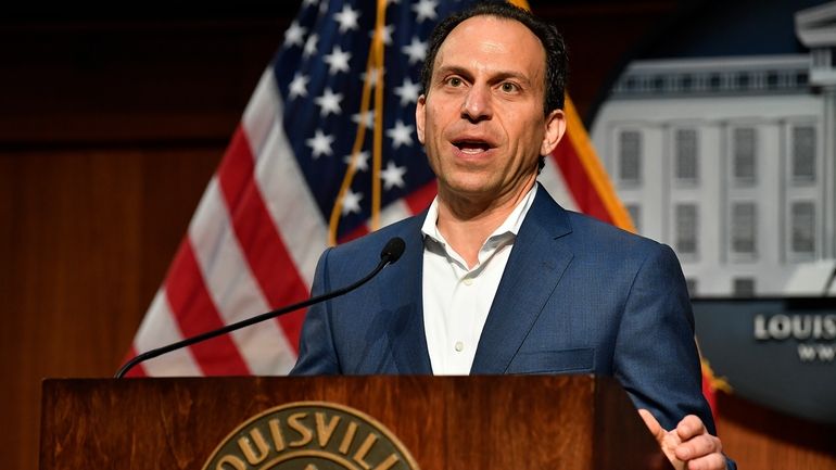 Louisville Mayor Craig Greenberg speaks to reporter during a news...