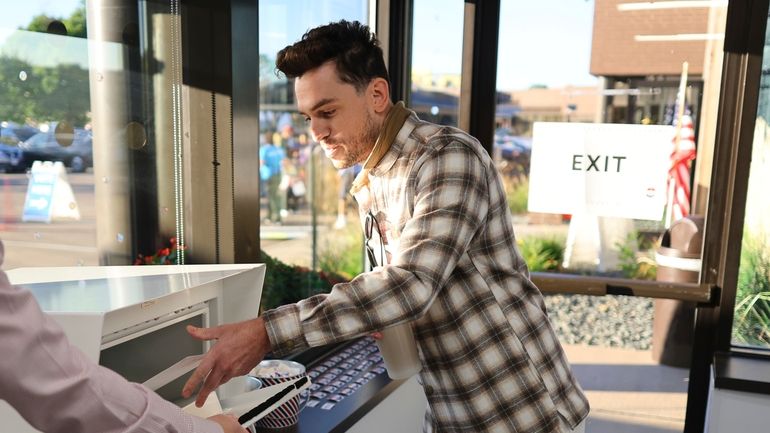 Minneapolis voter Jason Miller casts his ballot at the City...