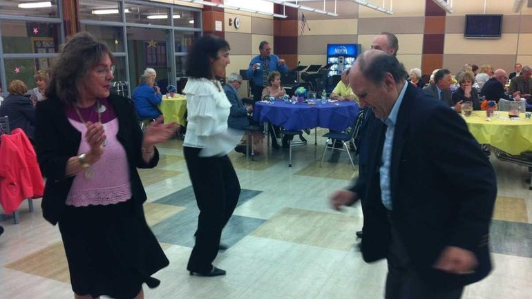 Sue Byrnes and Vincent Giudice, both of Sayville, take a...