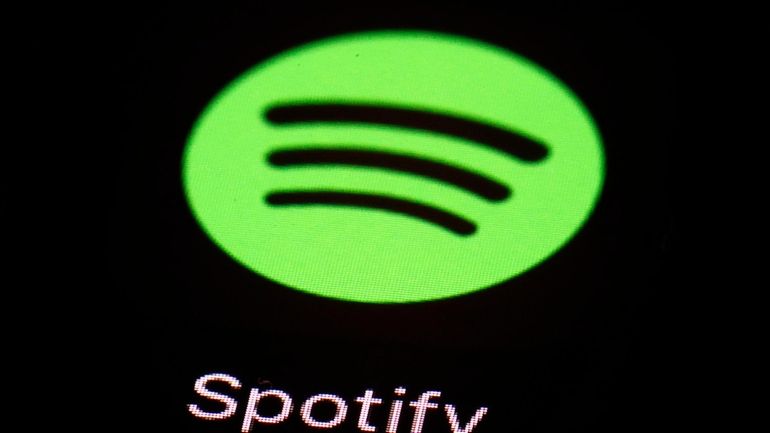 FILE- This March 20, 2018 file photo shows the Spotify...