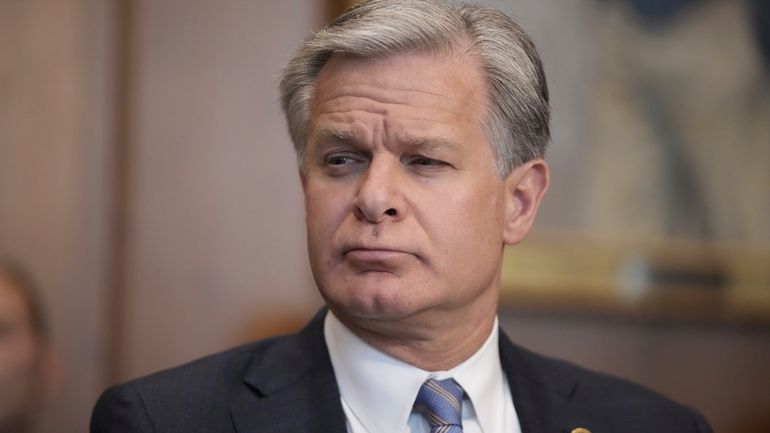 FBI Director Christopher Wray listens during a meeting of the...