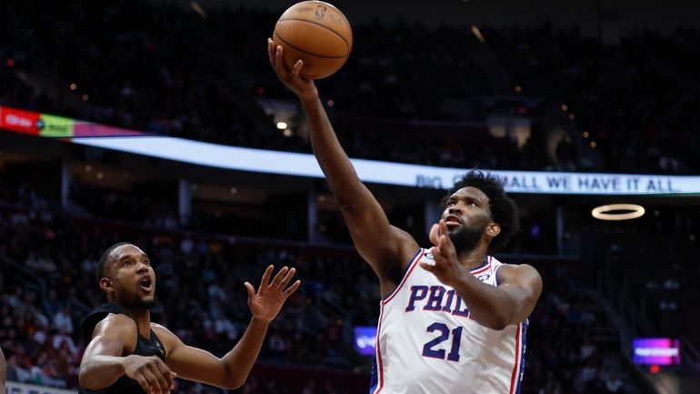 Philadelphia 76ers center Joel Embiid (21) shoots against Cleveland Cavaliers...