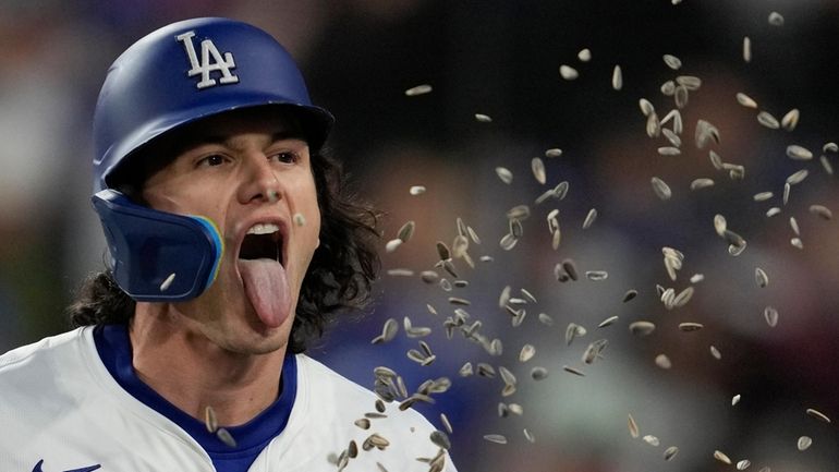 Los Angeles Dodgers' James Outman celebrates after hitting a home...