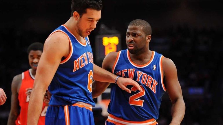 The Knicks' Landry Fields, left, holds off Raymond Felton as...