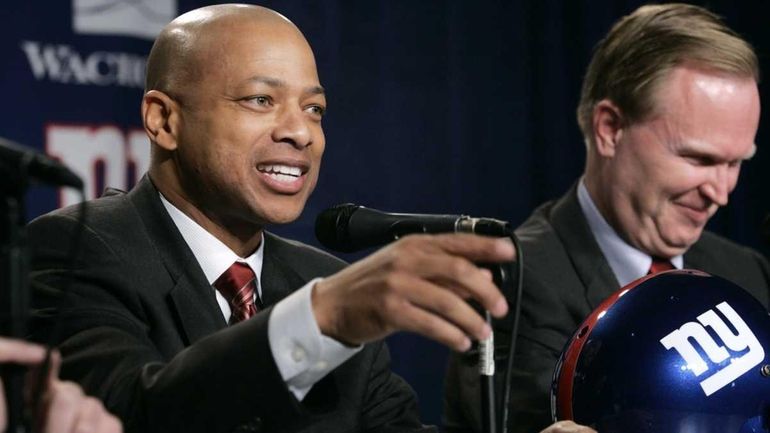 Jerry Reese gestures while responding to a question during a...