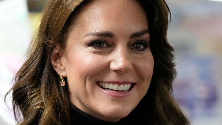 Britain's Kate, Princess of Wales smiles as she speaks to...