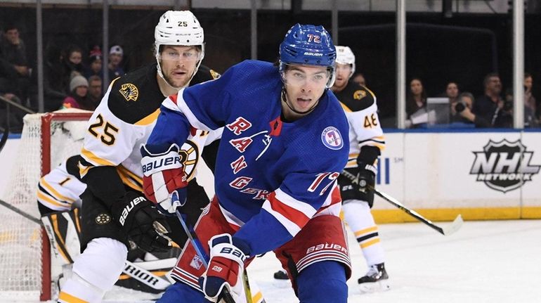 Rangers center Filip Chytil skates ahead of Boston Bruins defenseman...