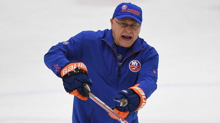 Islanders head coach Barry Trotz directs his players during training...