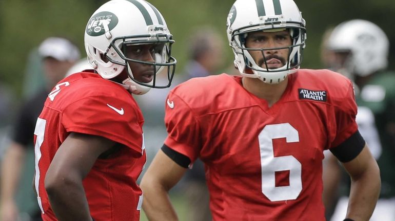 Geno Smith, left, and Mark Sanchez participate in a practice...