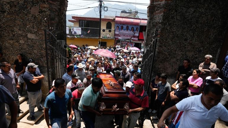 Relatives and friends carry the coffin that contain the remains...