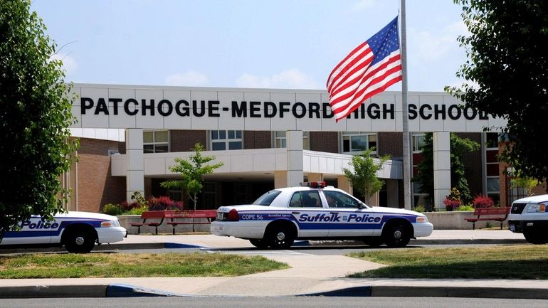 Police arrive at Patchogue-Medford High School after the school went...