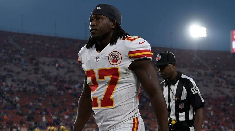 Running back Kareem Hunt walks on the sideline before a...