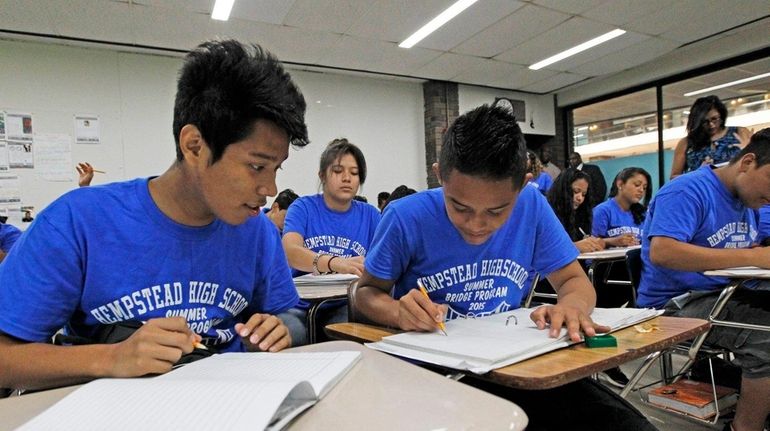 From left, Irvir Reyes, Axel Sanchez and classmates listen as...