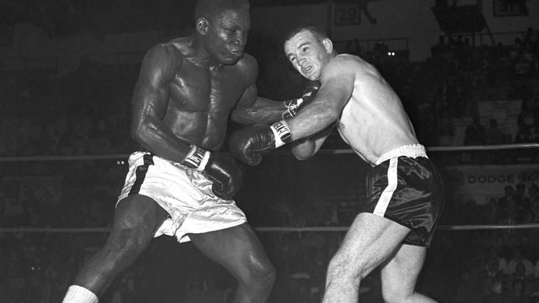 Former middleweight champion Dick Tiger, left, shakes up Don Fullmer...