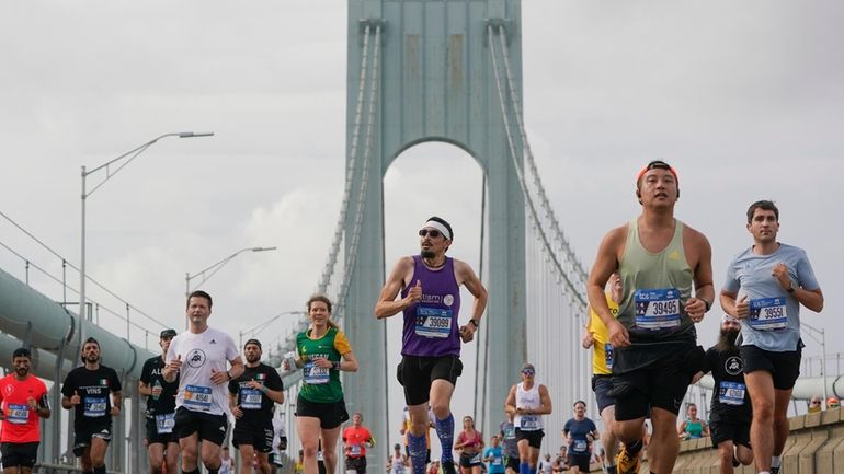 Runners cross the Verrazzano-Narrows Bridge at the start of the...