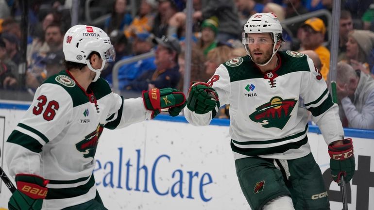 Minnesota Wild's Ryan Hartman, right, is congratulated by Mats Zuccarello...