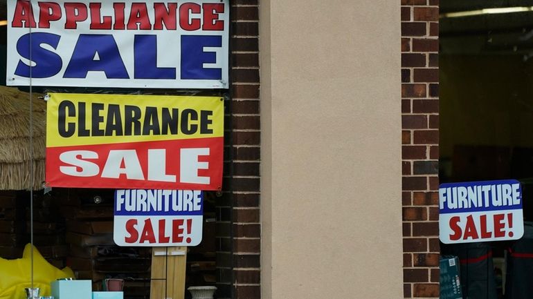 Sale signs are displayed at an appliance store in Arlington...