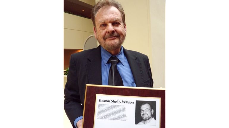 Associated Press Kentucky Broadcast Editor Tom Watson holds his plaque...