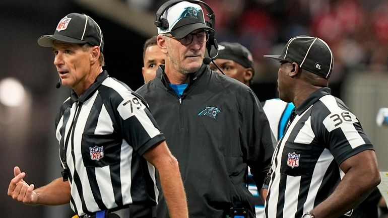 Carolina Panthers head coach Frank Reich speaks with field judge...