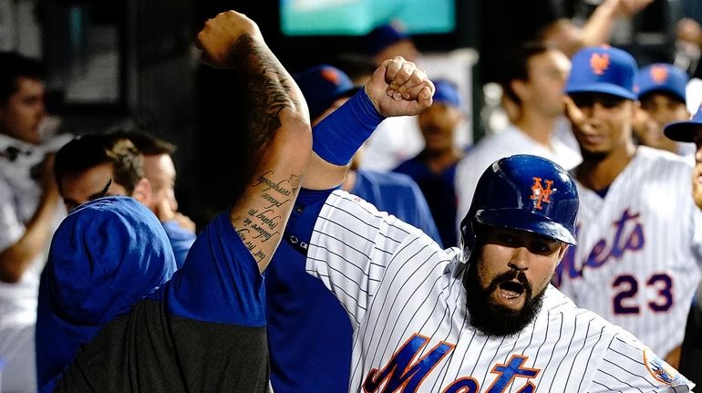 Mets shortstop Luis Guillorme (13) is greeted in the dugout...