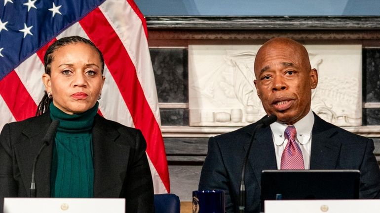 Mayor Eric Adams, right, is flanked by deputy mayor Sheena...