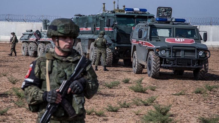 Turkish and Russian soldiers patrol near the town of Darbasiyah,...