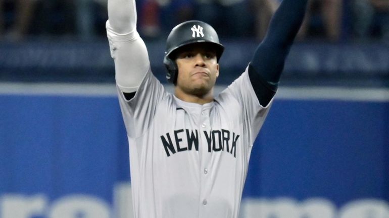 The Yankees' Juan Soto celebrates at second base after hitting...