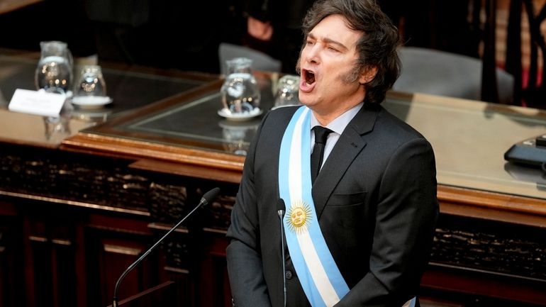 Argentina's President Javier Milei sings the national anthem as he...