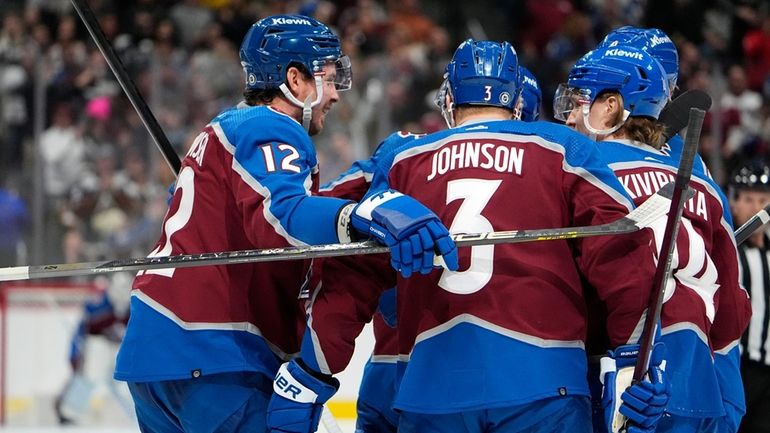 Colorado Avalanche center Ryan Johansen, left, celebrates after scoring a...