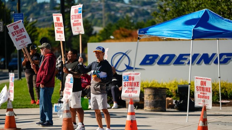 Boeing employees Cham Sin, in black, and Lou Saephanh, right...