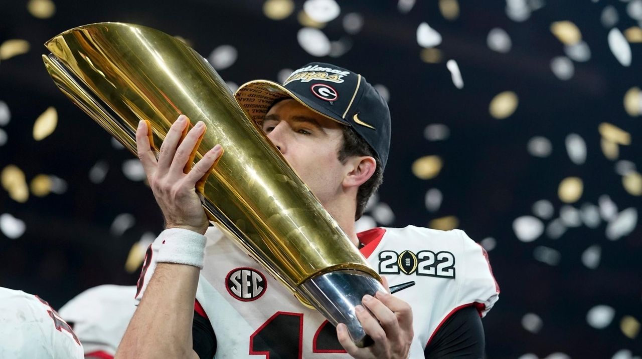 Georgia Bulldogs defensive lineman Jordan Davis (99) celebrating during the  trophy presentation of the 2022 CFP college football national championship  game at Lucas Oil Stadium, Monday, Jan. 10, 2022, in Indianapolis. Georgia