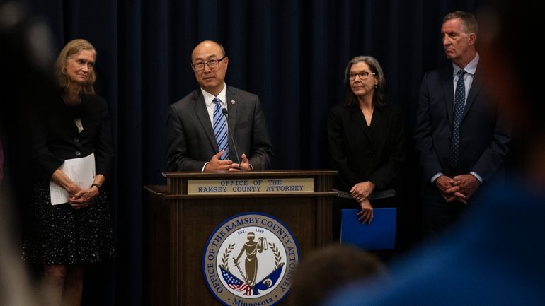 Ramsey County Attorney John Choi, at podium, discusses his office's...