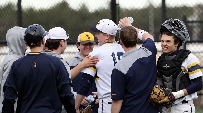 Shoreham-Wading River's starting pitcher Aidan Crowley (18) gets a minor...