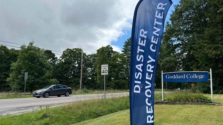 A FEMA disaster recovery center sign sits in Plainfield, Vt.,...