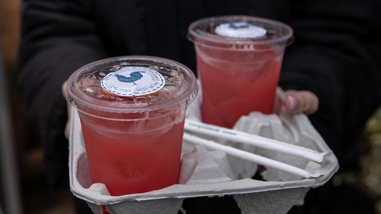 Cocktails are for sale to go at a bar and...