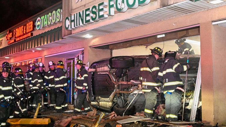 Firefighters at the scene of the crash at Great Wall Kitchen...